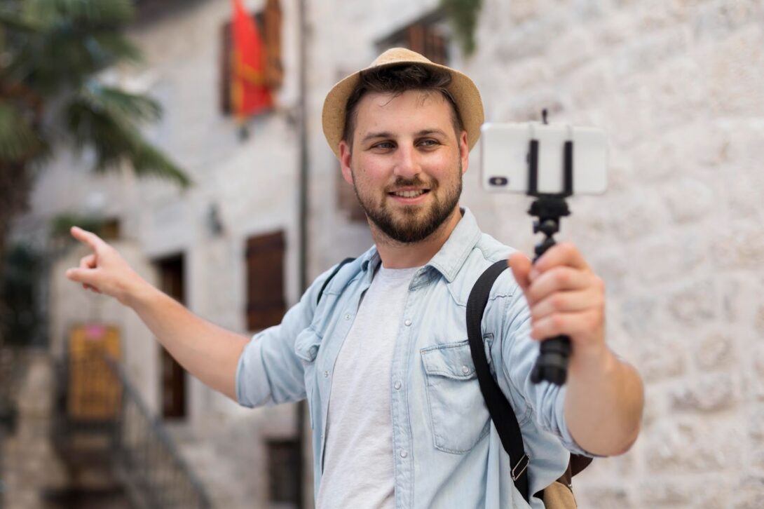 Male traveler making a video