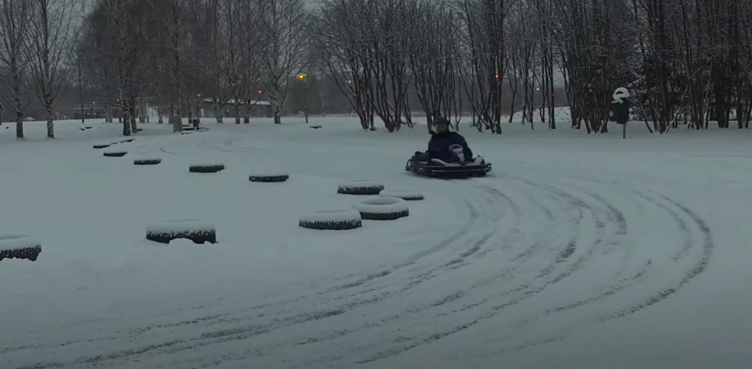 Someone riding a go-kart on snow