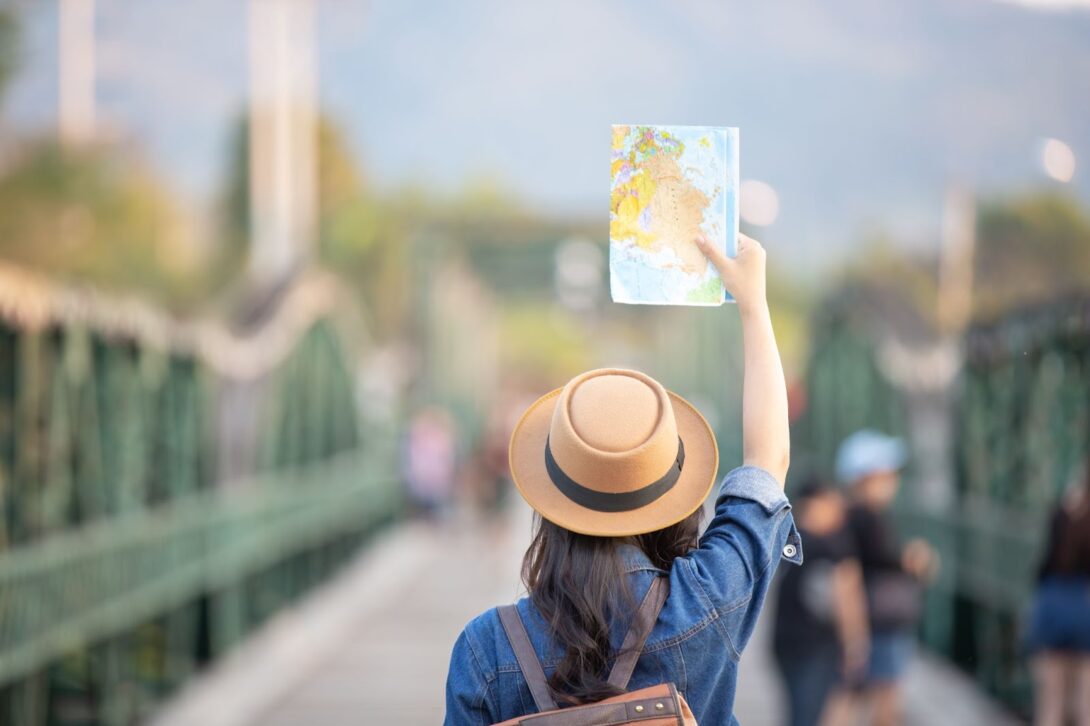 Woman holding a map over her head