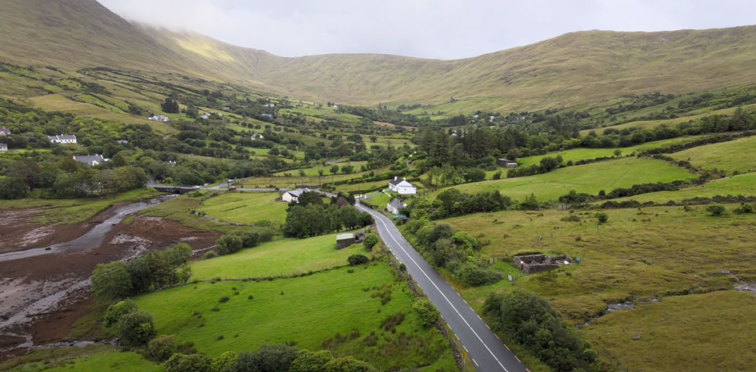 Long highway with green surroundings