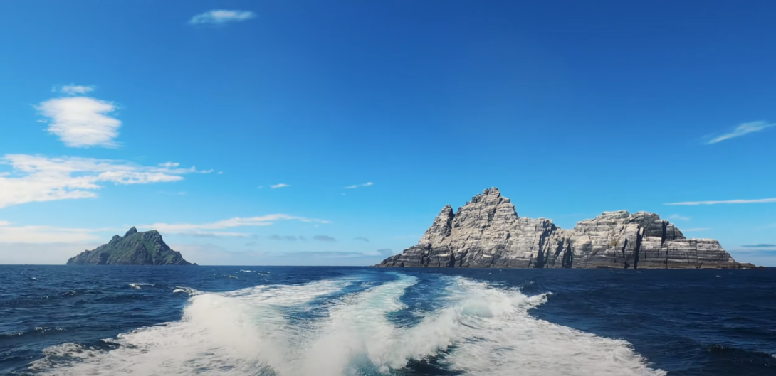 View of rippling water with two distant islands