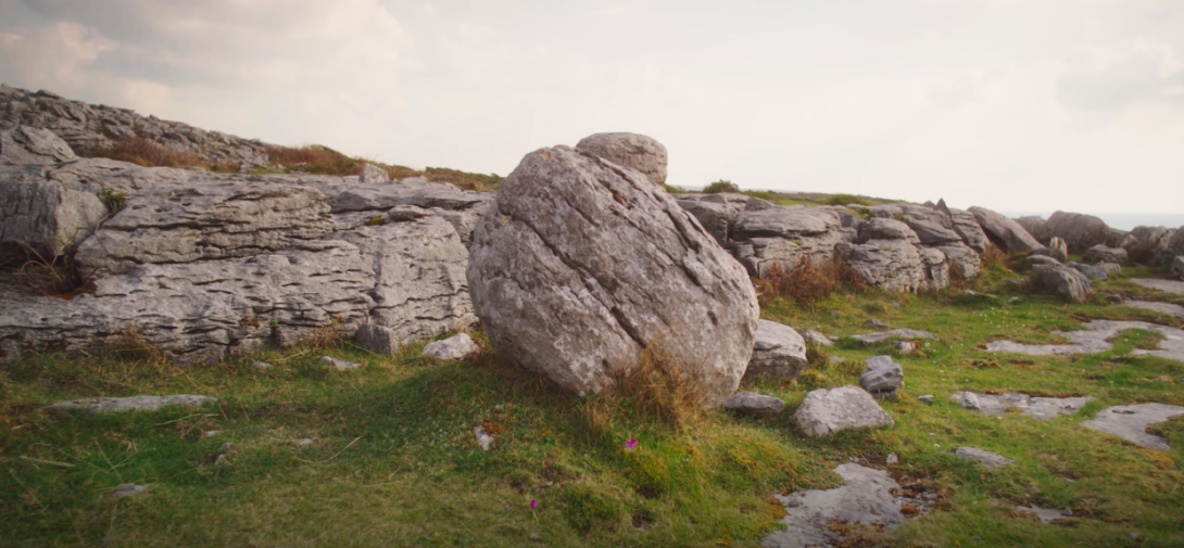 Image of rocky formations and a grassy field