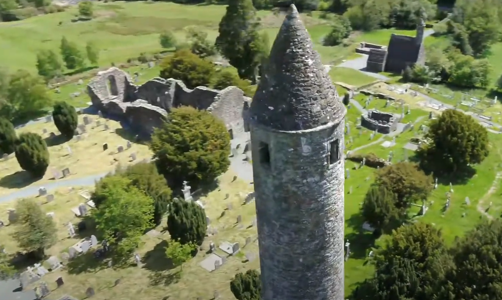 An aerial view of a round tower with surrounding structures