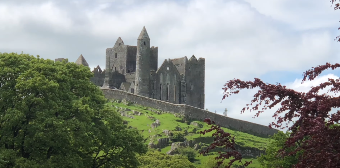 A distant view of the Rock of Cashel with lush green surroundings