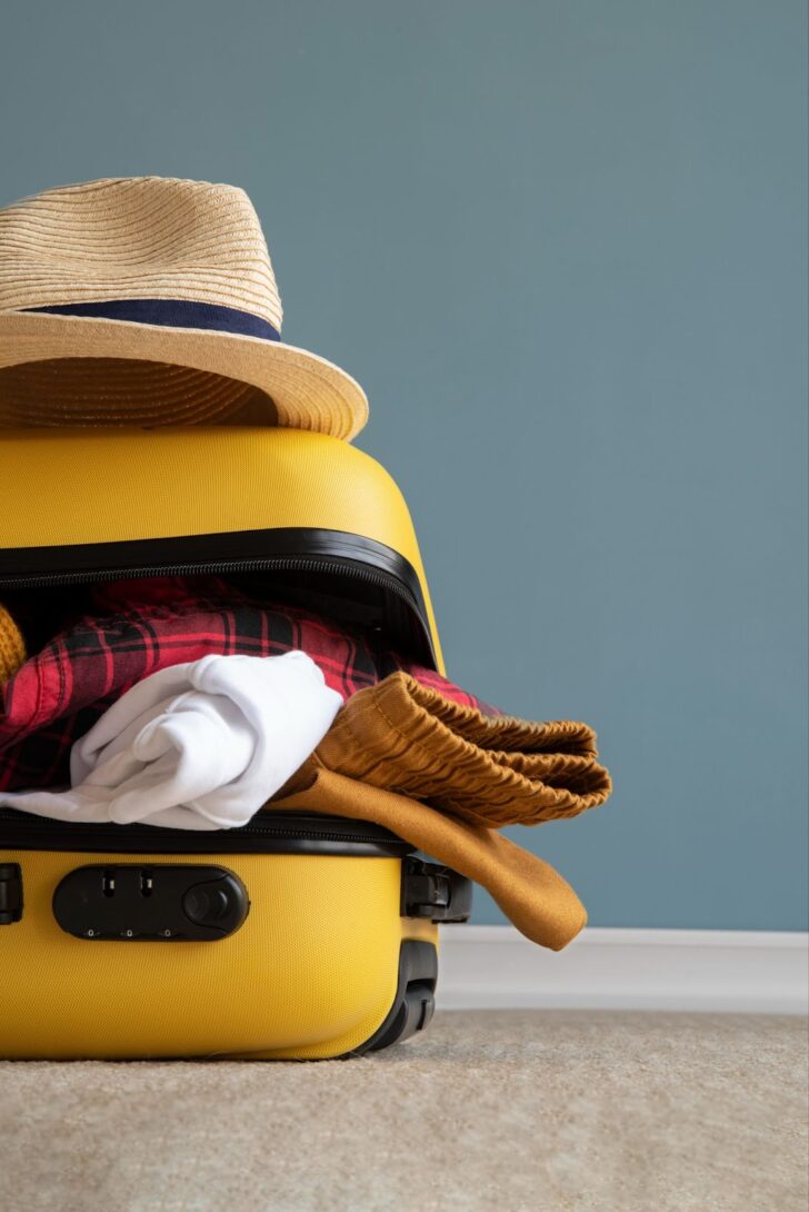 Close up of yellow suitcase full of stuff