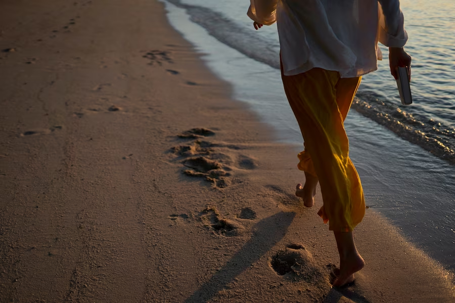 Person strolling along the beach