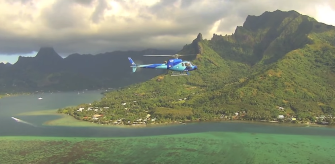 Helicopter above green scenery