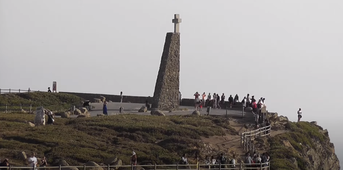 Hill featuring a tall tower with a cross atop