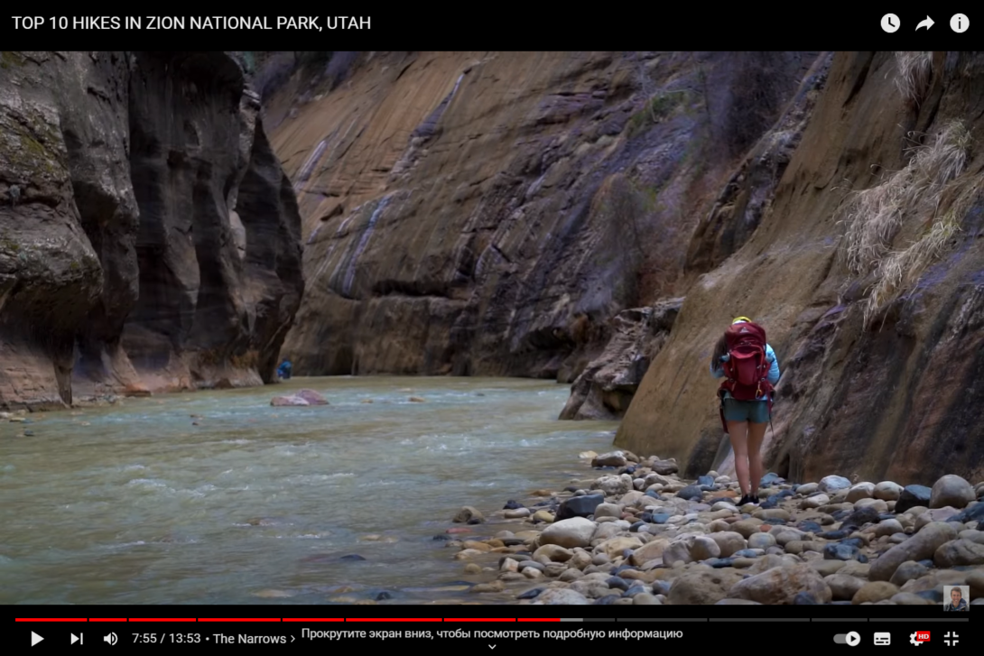 A man walks along the rocky terrain along the river