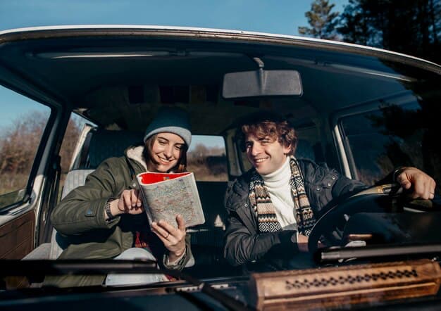 Young couple looking at a book in the car