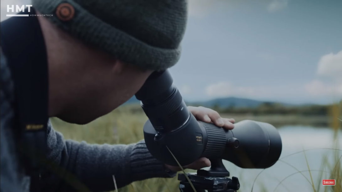 the man is looking through the scope