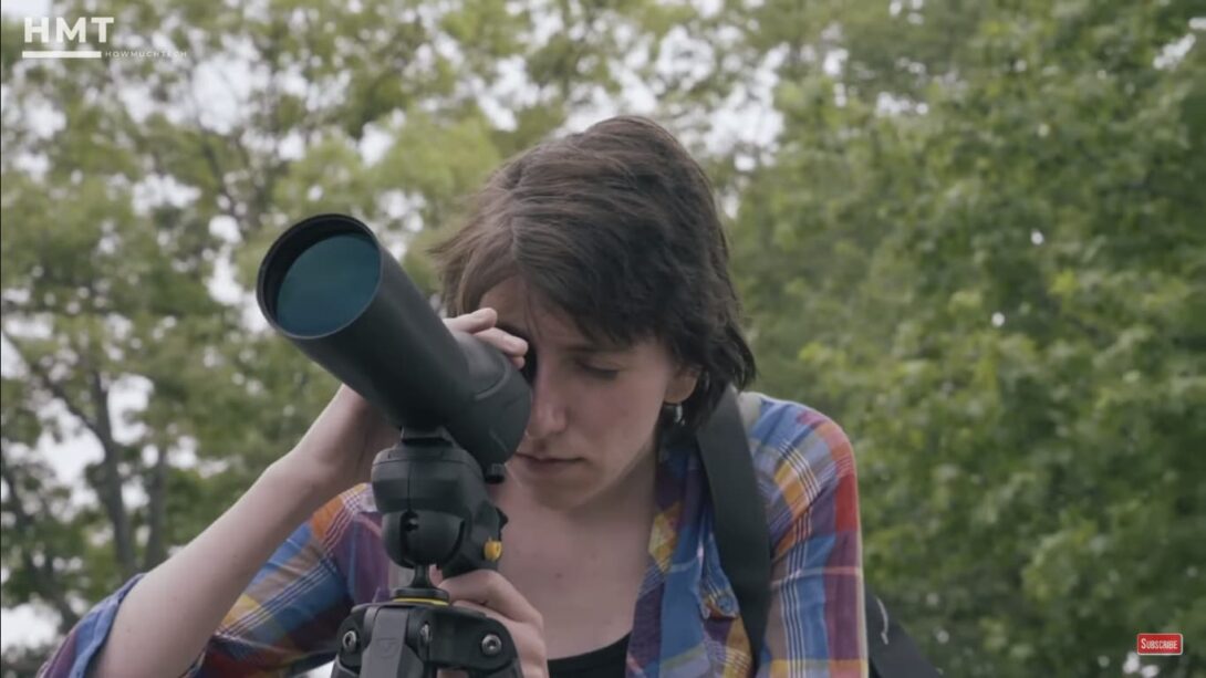 a woman looking through the scope